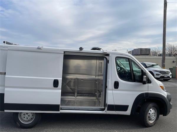 2023 Dodge ProMaster 3500; white, no branding; back is fully outfitted for animal transport